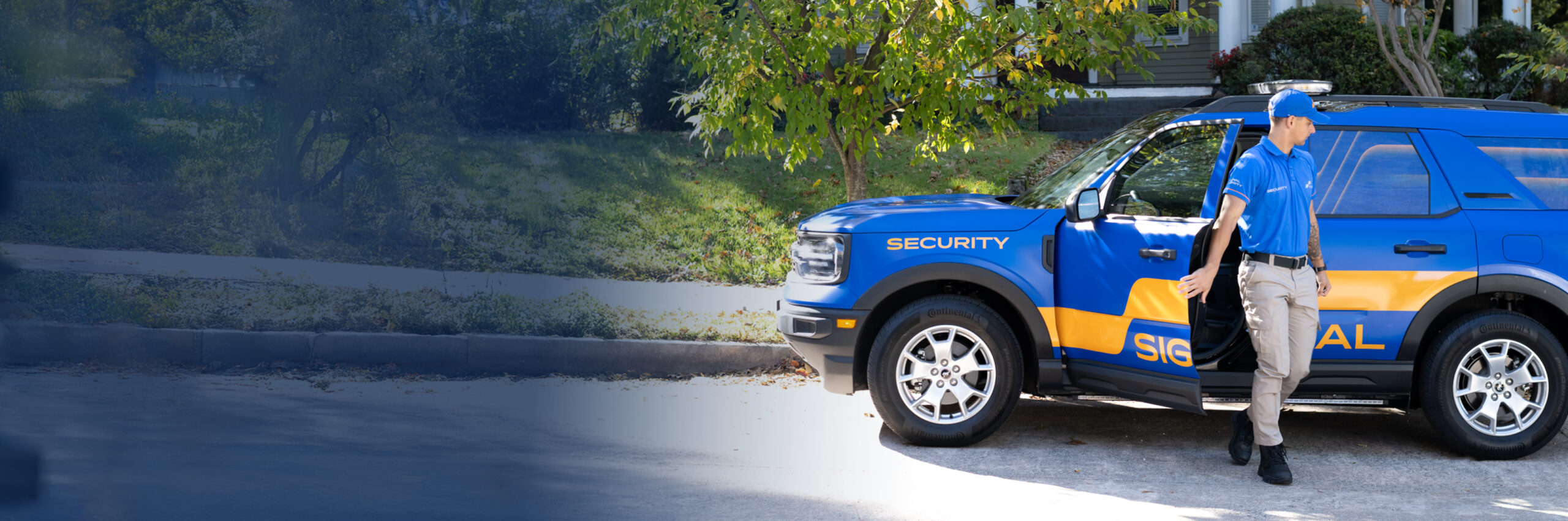 Signal Security officer beside a marked patrol SUV
